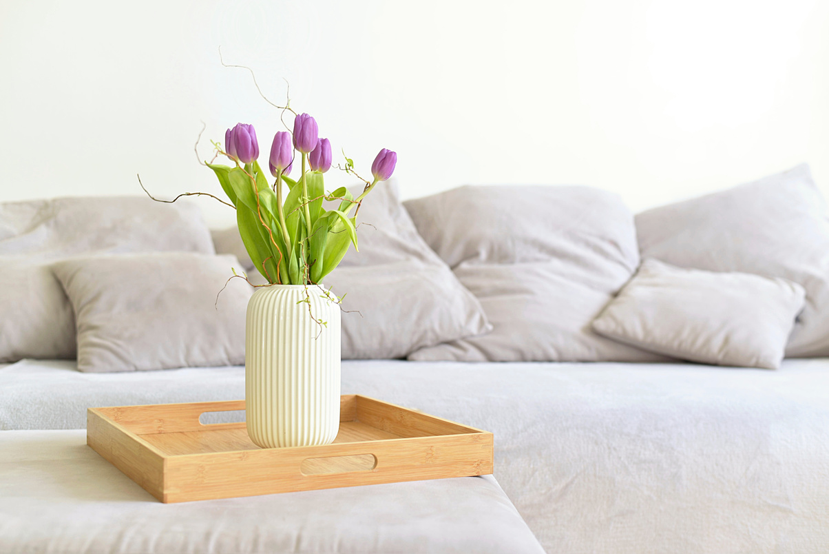 bouquet of tulips on a tray and in the background with gray sofa